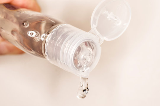 Hand sanitiser bottle close-up, pouring anti-bacterial gel for health and safety. Good hygiene and cleaning concept. 