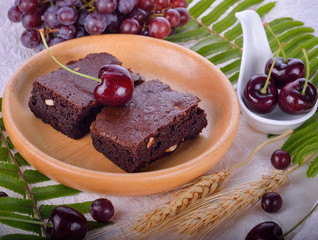  brownies on a plate wooden background.