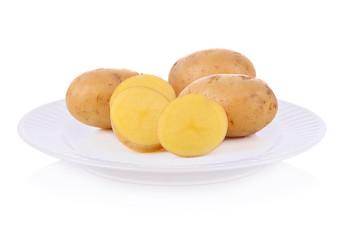 Fresh potatoes on plate isolated on white background.