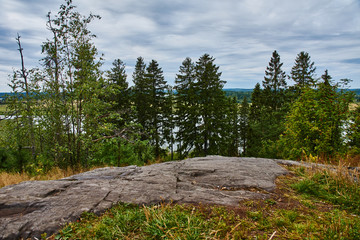 Panorama of Karelian nature from a height.Panoramic view of the surroundings of Sortavala from a hill in a city park: a forest of conifers, traces of volcanic lava, rocks and volcanic rocks. Russia