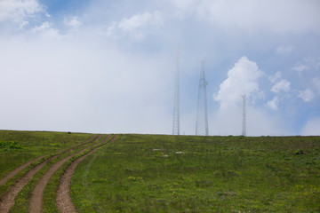 Obraz premium Abstract telecommunications tower antenna and satellite dish in the background of sunset sky in nature