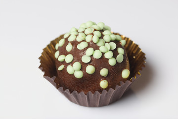 Chocolate Potato Cake. Decorated with sprinkles. On white background.