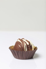 Chocolate Potato Cake. Garnished with trickles of chocolate. On white background.