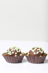 Chocolate Potato Cake. Decorated with sprinkles. On white background.