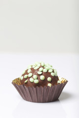 Chocolate Potato Cake. Decorated with sprinkles. On white background.
