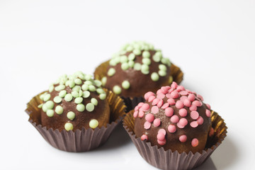 Chocolate Potato Cake. Decorated with sprinkles. On white background.