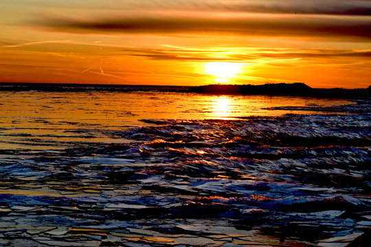sunset over the sea Huron lake, Goderich, Ontario, Canada, 7 March 2020, a beautiful sunset on the Huron lake in Goderich beach with Ice Float up on the surface  