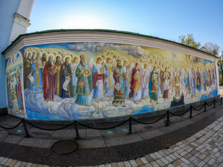 An entrance wall to St Michael's Golden Domed Cathedral in Kiev. The wall is covered with paintings of saints and angels. Fish eye effect.