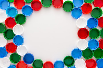 Frame of colored plastic caps. Copy space.
