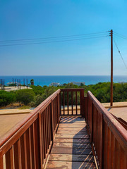 View to the Mediterranean sea from wooden stairs in Cyprus