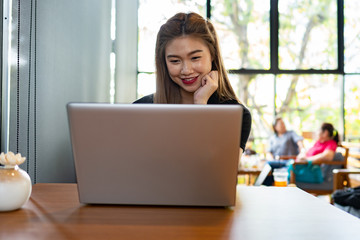 Naklejka premium Beautiful Attractive Asian woman working with computer laptop and thinking to get ideas and requirement in Business startup feeling so happiness,Business Startup Concept