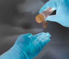 hand in glove holding a syringe