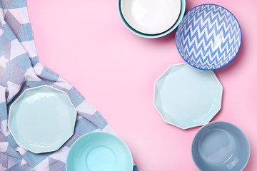 Empty ceramic tableware. Ceramic plates on pink background. Overview empty food table with tableware. Set of different modern white and blue plates and bowls.Top view, flat lay.Copy space for text