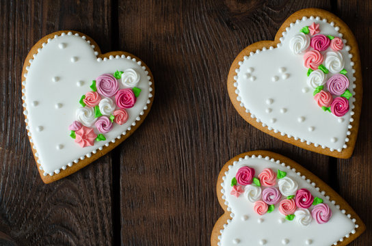 Gingerbread hearts on wooden background. Top view. Ginger biscuits.