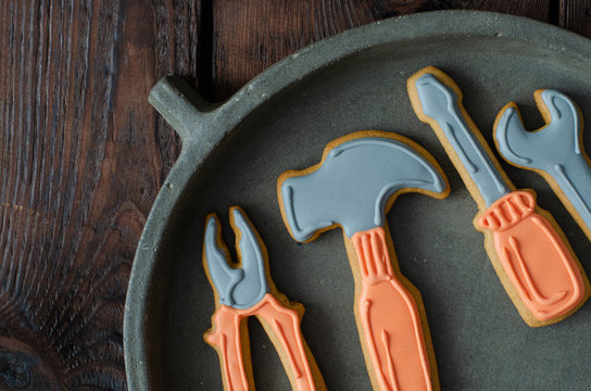 Gingerbread tool kit on concrete dish on wooden background. Top view. Ginger biscuits.