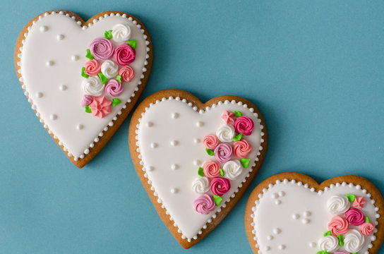 Gingerbread hearts on blue background. Top view. Ginger biscuits.