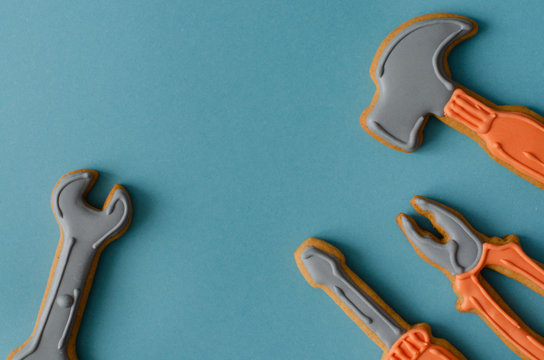 Gingerbread tool kit on blue background with copy space. Top view.