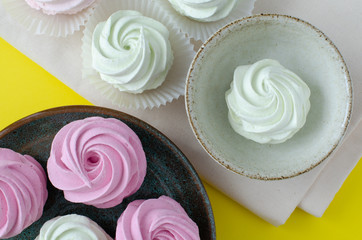 marshmallow on dish on yellow background. Marshmallow in cup. Marshmallow on linen.