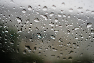 Water droplets  on the glass of car for background