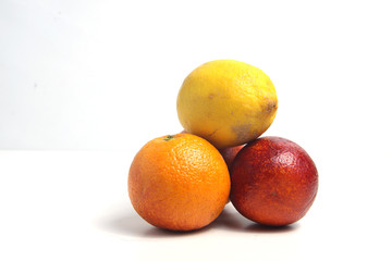 a pile of citrus fruits isolated on white background