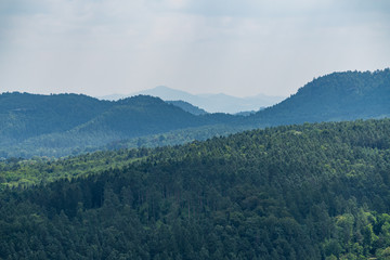 Königstein fortress on the banks of the Elbe river, green landscape with mountains in the background. Dresden, Saxon Switzerland, Germany.