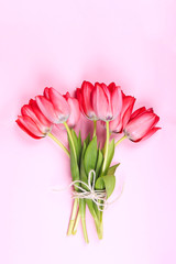 Fototapeta premium Bouquet of Pink Tulips and ribbon. Easter day background.