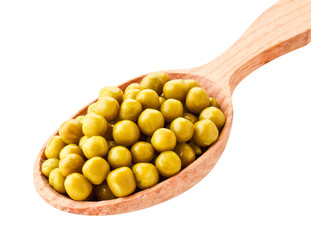 Canned green peas in a wooden spoon close-up on a white. Isolated