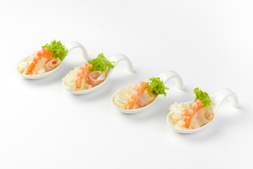 Snack with shrimp and apple in a glass boat on a white background