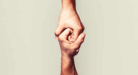 Helping hand outstretched, isolated arm, salvation. Close up help hand. Helping hand concept and international day of peace, support. Two hands, helping arm of a friend, teamwork - obrazy, fototapety, plakaty