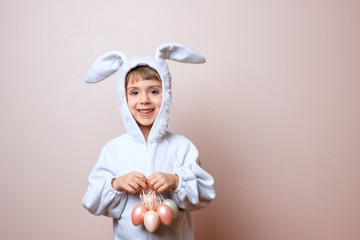 Cute little child girl wearing bunny costume on Easter day. Girl with Easter eggs in the basket.