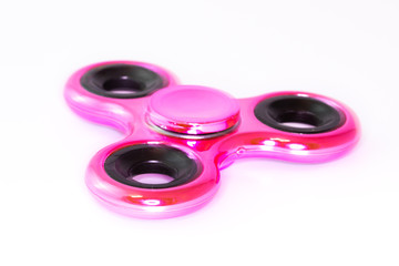 Pink spinner stress relieving toy on white background