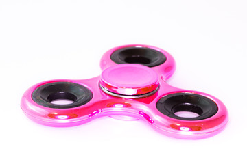 Pink spinner stress relieving toy on white background