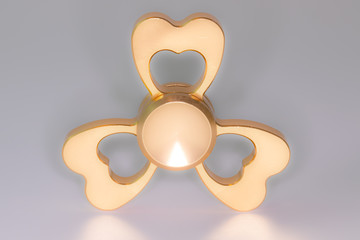 Golden spinner stress relieving toy on white background