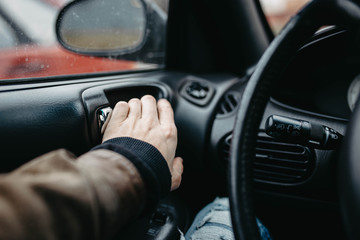 driver opens the car door from the inside, leather upholstery.