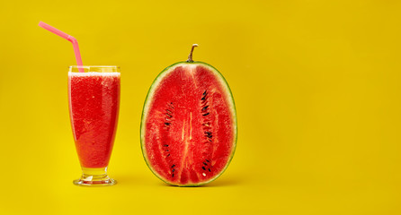 Watermelon smoothie and half a watermelon on a yellow background. Minimal style. Space for text.