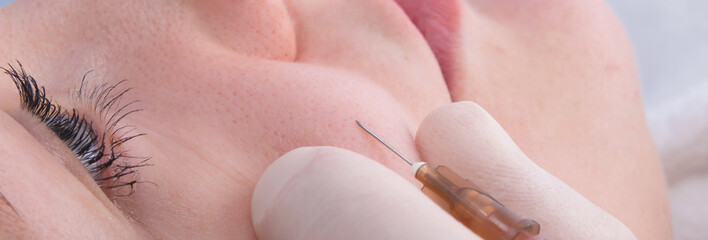 close-up, a procedure to improve the quality of skin on the face, using an injection