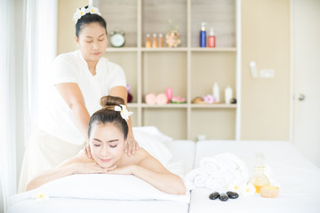 An Asian lady is in the spa. Woman is relaxing getting Thai massaging side view