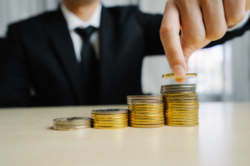 Businessman working with coin money currency. Concept of investment growth and money saving.