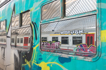 graffiti on the train in a station hall © Heinz