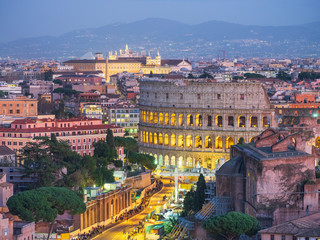 Fototapeta na wymiar night street lights around colosseum in twilight in Rome