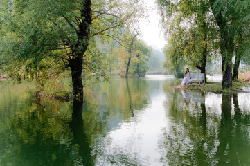 Young Lady on River Shore Enjoying Fresh Air and Calmness of Countryside in Huairou District,...