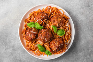 Spaghetti pasta with meatballs, tomato sauce, parmesan cheese and basil. italian food