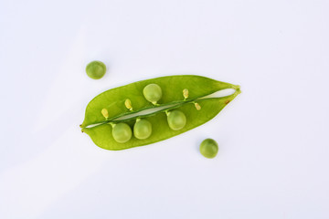 Fresh open green peas isolated on a white background