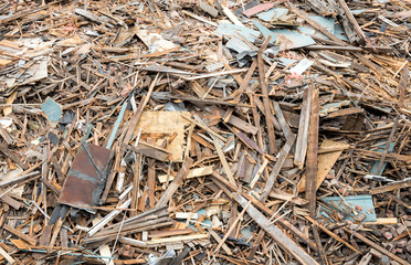 Closeup view of a large pile of rubble and debris from a demolished building. The pile consists of wood, brick, plaster, etc. 