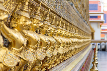 Fototapeta premium Perspective photo of Golden Statue Garuda at Wat Phra Kaew Temple, Bangkok, Thailand
