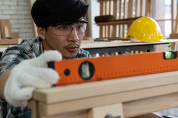 Carpenter working on wood craft at workshop to produce construction material or wooden furniture....