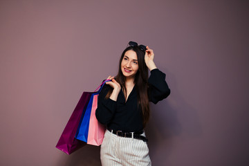 Young happy summer shopping woman with shopping bags isolated on background