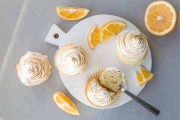 Lemon cupcakes with Italian meringue. Delicious homemade cakes. Top view, close- up, copy space.