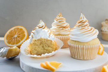 Lemon cupcakes with Italian meringue. D elicious h omemade c akes. Side view, close- up, copy space.