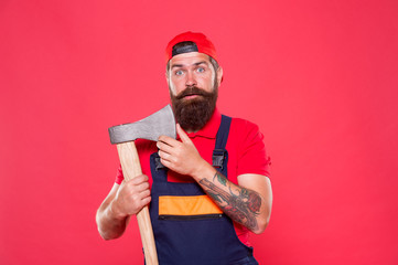 Dismantling and demolition of structures. Bearded lumberjack. Man builder uniform hold axe. Man builder hold ax red background. Renovation concept. Bearded handyman. Brave worker. Brutal job